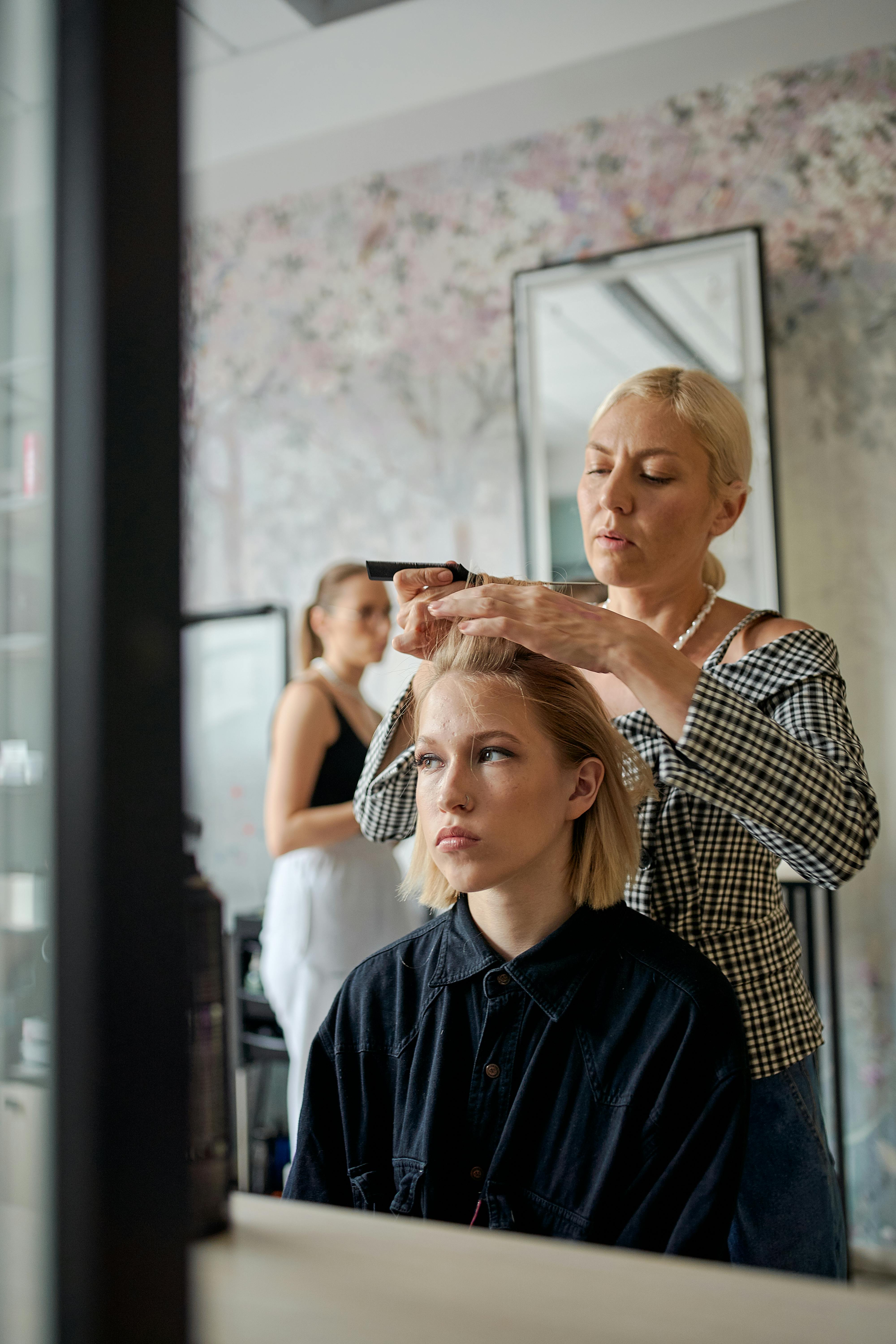 Professional hair stylist working with a client