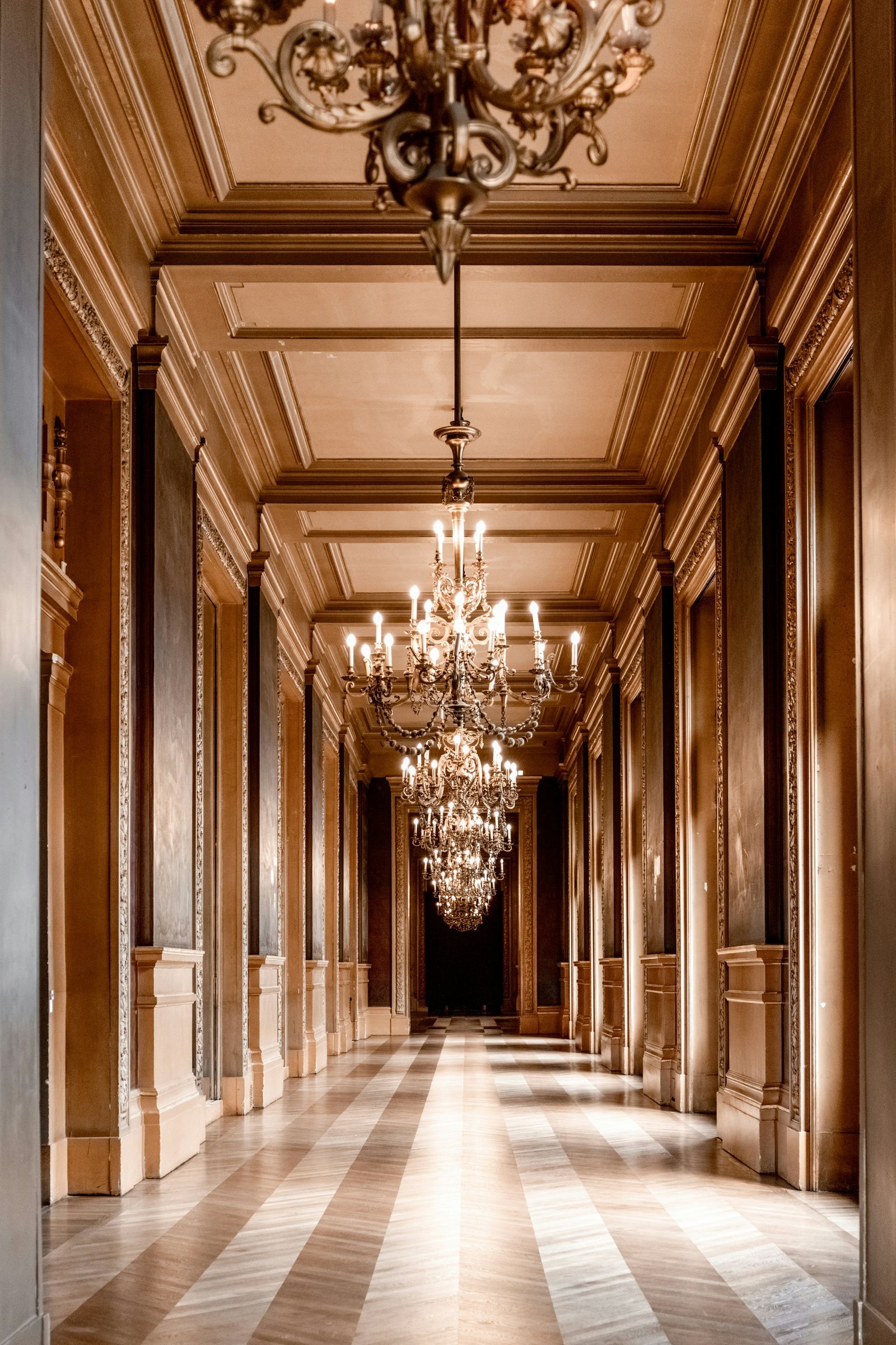 Sunlit hallway inside Aurora House with warm wood paneling