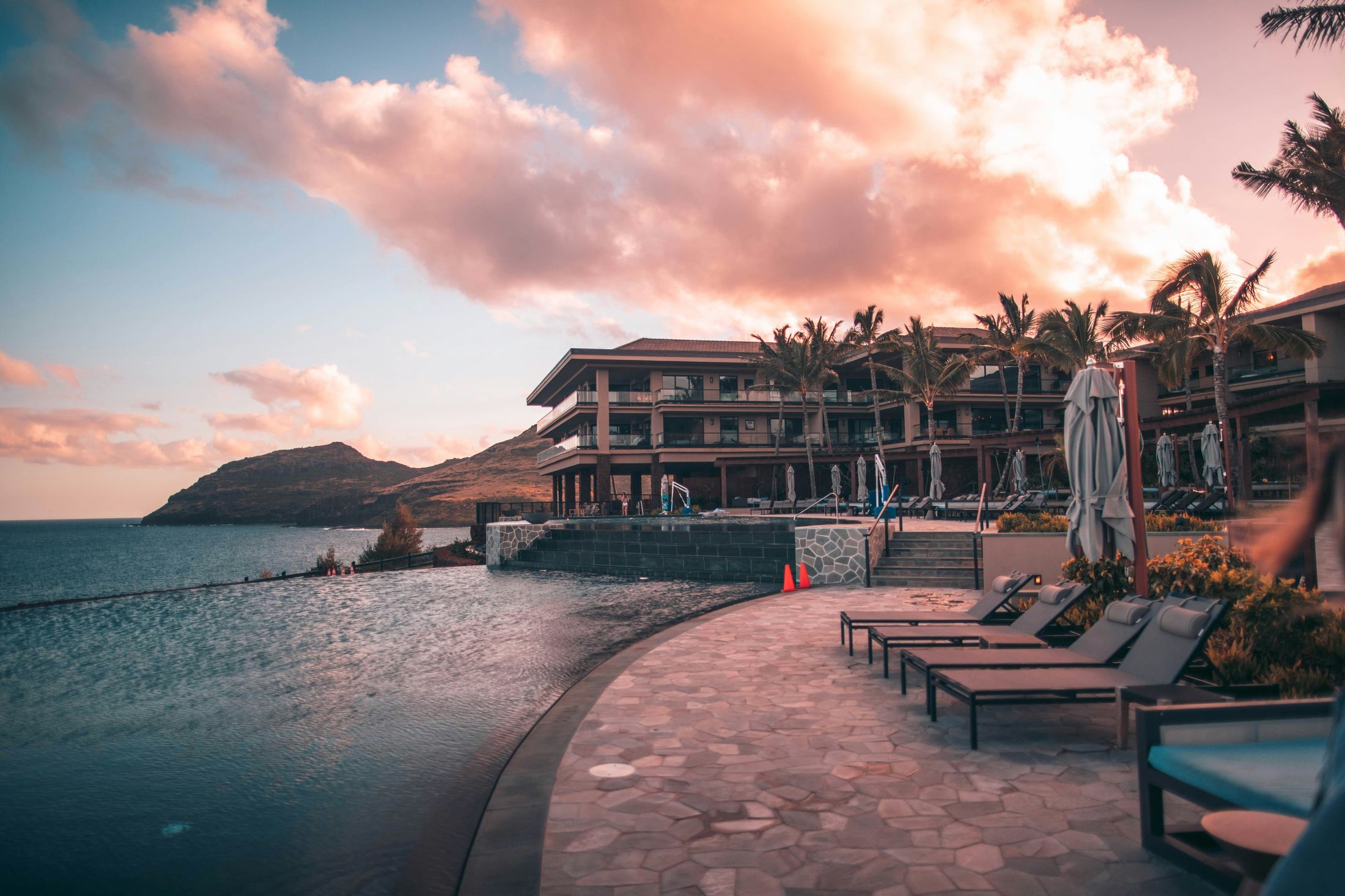 Aurora House exterior with rooftop infinity pool at dusk