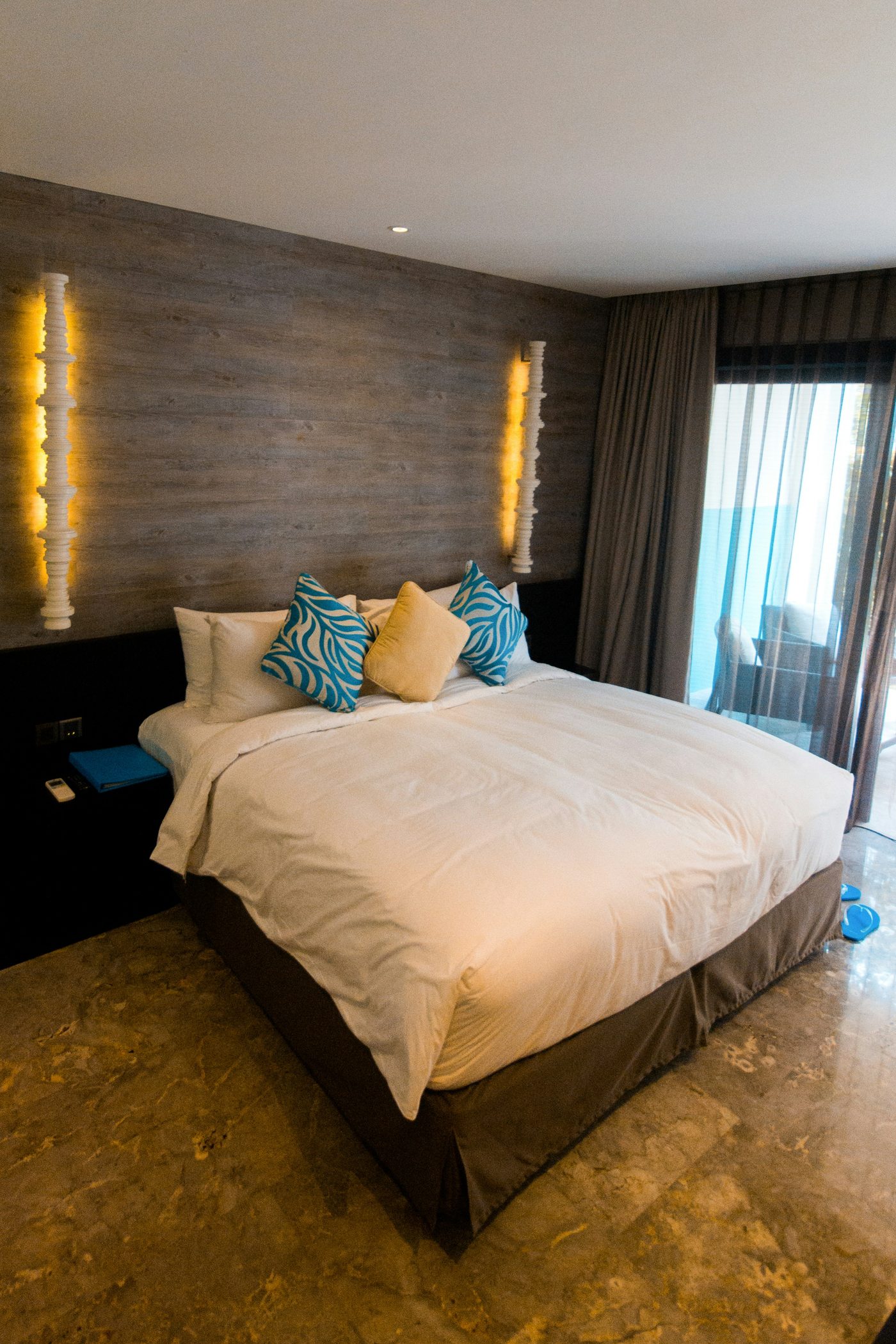 Superior Room with warm wood-panelled walls and teal accents