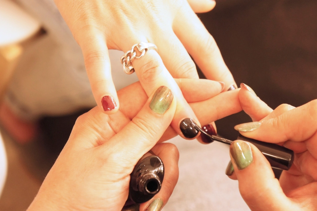 Professional manicure in progress at a nail studio