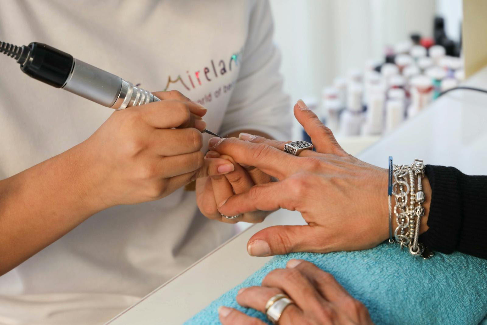 Nail treatment detail in progress.