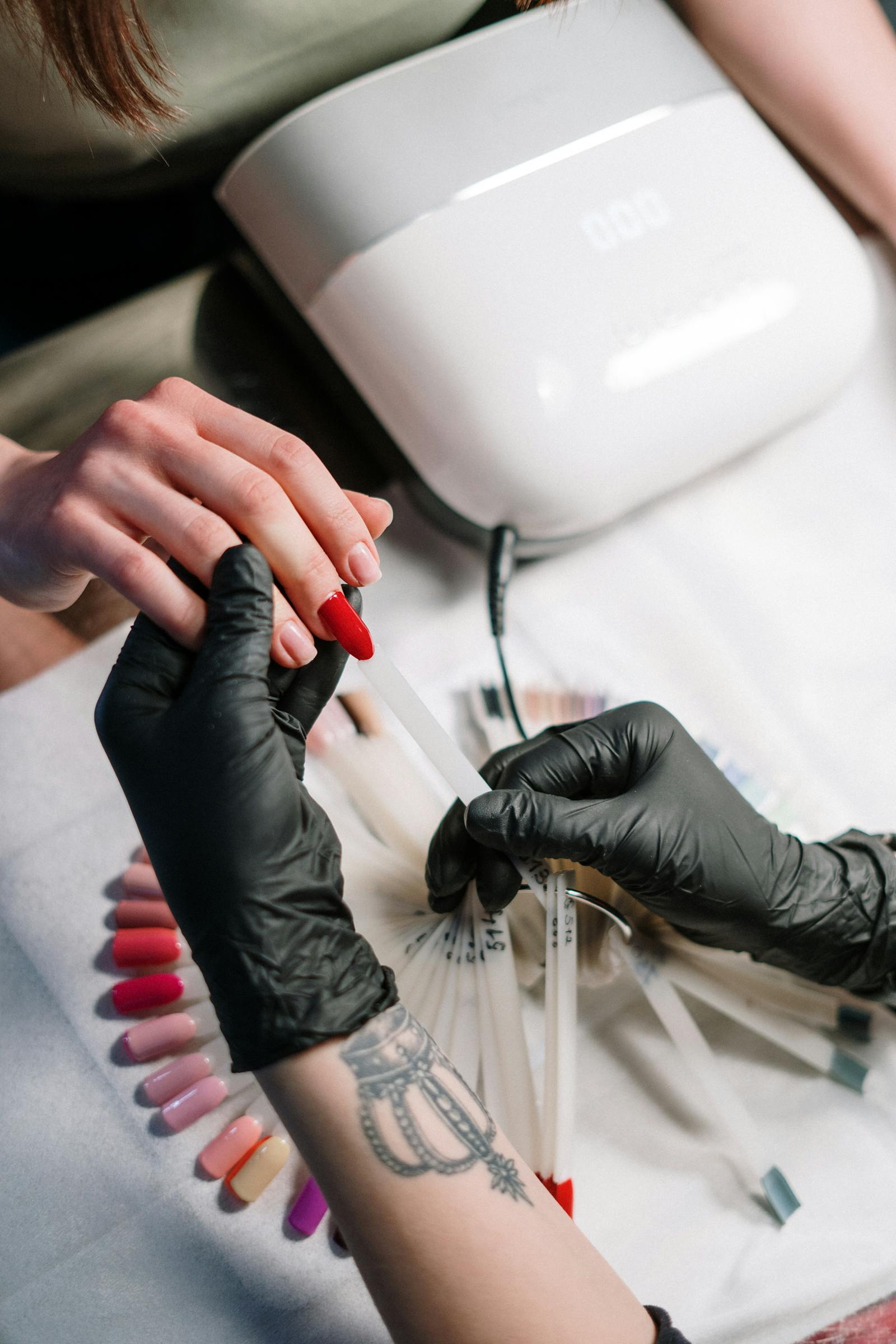 Nail technician preparing manicure color set.